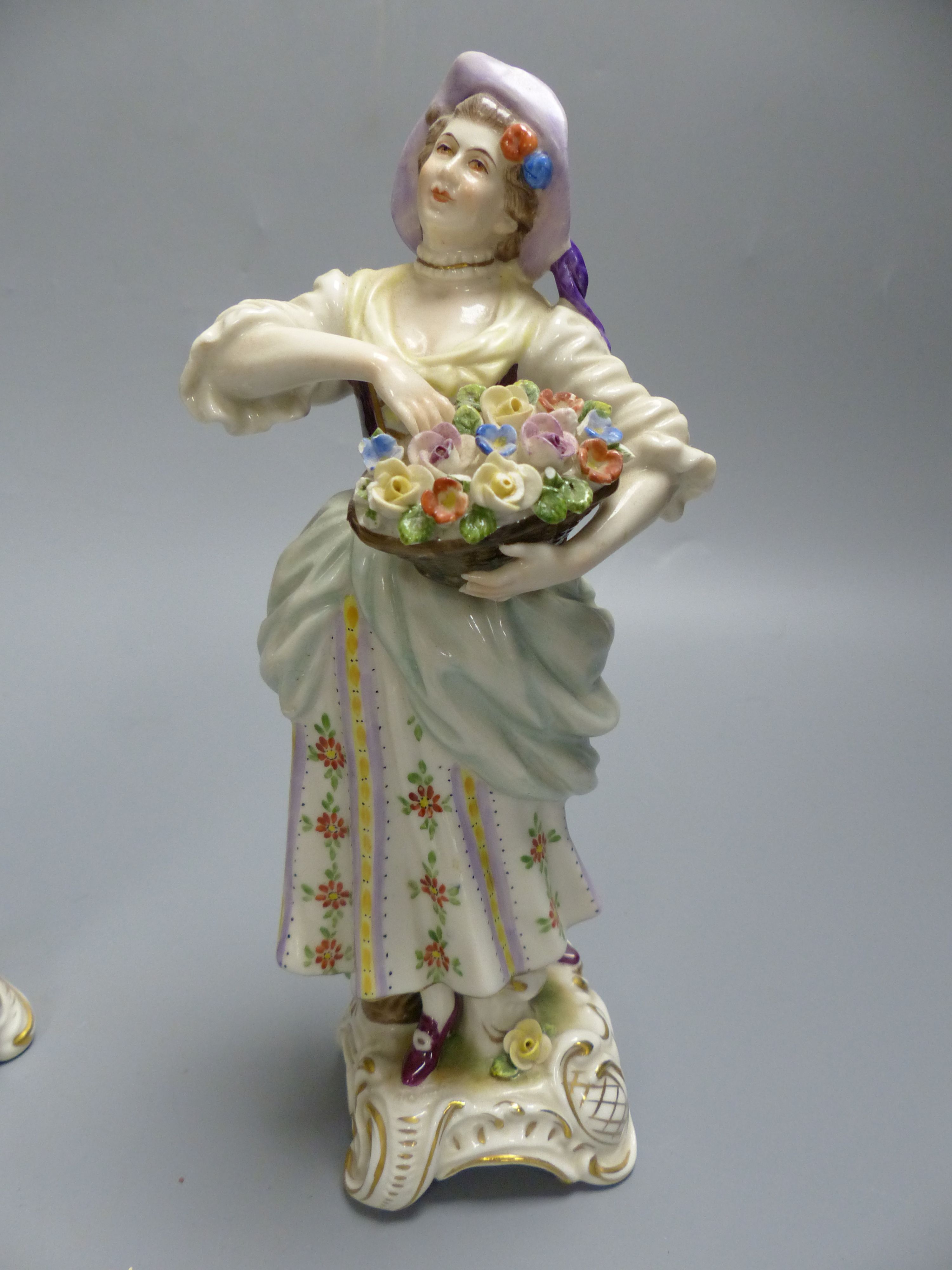 A pair of Rudolf Kammer porcelain figures of flower carriers, height 23cm